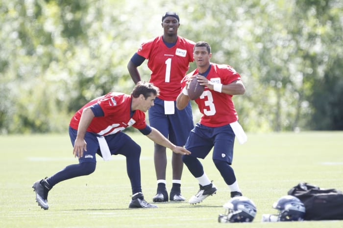 Jun 12, 2013; Renton, WA, USA; Seattle Seahawks quarterback Russell Wilson (3) and quarterback Brady Quinn (10) do a drill following minicamp practice at the Virginia Mason Athletic Center. Seattle Seahawks quarterback Jerrod Johnson (1) stands behind Wilson and Quinn.